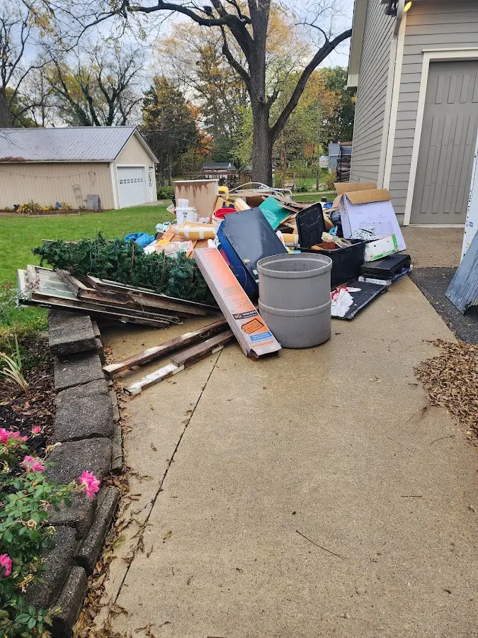 Dumpster being loaded with debris for Estate Cleanout Dumpster Rental in Wenham